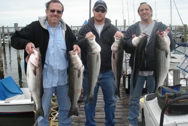 Capt. Karl Chunking Stripers on the old boat!